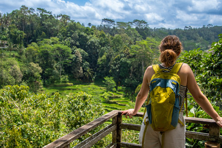 Woman with backpack looking at tea plantation in Bali, Indonesia.の写真素材