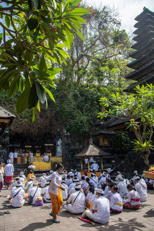 Bali, Indonesia September 5, 2022, Devout Hindus at a ceremony in front of the "Goa Lawah" Templeのeditorial素材