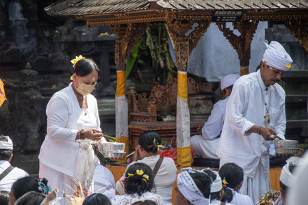 Bali, Indonesia September 5, 2022, Devout Hindus at a ceremony at the "Goa Lawah" templeのeditorial素材