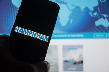 Rheinbach, Germany 28 September 2025, The brand logo of the Icelandic company "Hampidjan" on the display of a smartphone in front of the website (focus on the brand logo)のeditorial素材