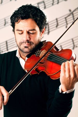 Musician playing violin with stave backgroundの写真素材