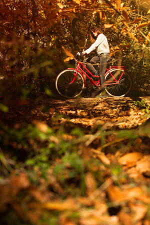 Woman with a bike in the middle of the forestの写真素材