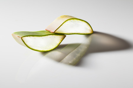 Close up stack of freshly sliced Aloe Vera on white backgroundの写真素材