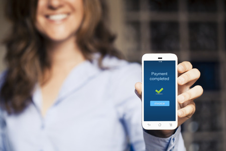 Smiling woman showing her mobile phone.