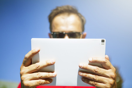 Close up detail of tablet being used by a man.の写真素材
