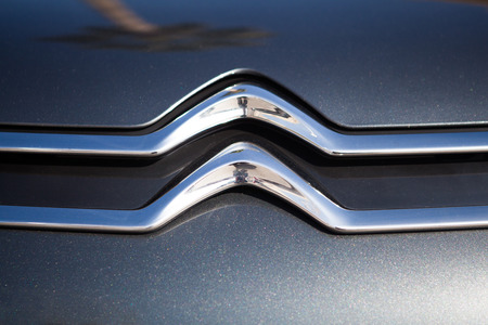 MALAGA, SPAIN - DECEMBER 2, 2015: Citroen car front logo over grey painted car. Close up detail of Citroen brand logo in a car. Citroen was founded in 1919 by French industrialist Andre-Gustave Citroen and was the first mass-production car company outsideのeditorial素材