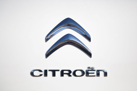 MALAGA, SPAIN - DECEMBER 2, 2015: Citroen car front logo over white painted car. Close up detail of...