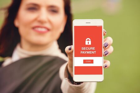 Secure payment message on a mobile phone screen. Woman holding smartphone in the hand.の写真素材