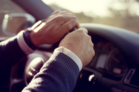 Man hands holding steering wheel.の写真素材