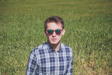 Man in sunglasses posing outdoors.