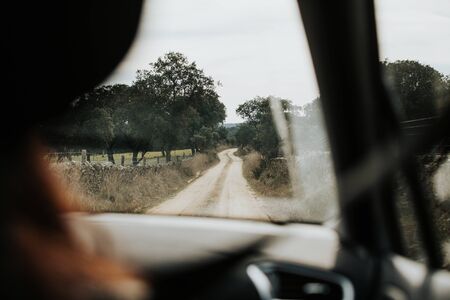 Rural path view from car interior. Adventure concept.の写真素材
