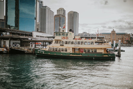 SYDNEY, AUSTRALIA - FEBRUARY 26, 2017: Cityscape of Sydney Harbor with a popular touristic boat in...