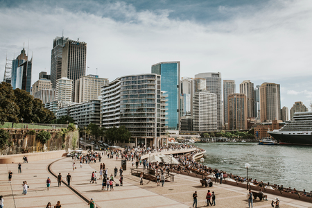 SYDNEY, AUSTRALIA - FEBRUARY 26, 2017: Sydney cityscape view from Opera House, with lot of tourists walking around the harbour, on February 26th, 2017 in Sydney, New South Wales, Australia.のeditorial素材