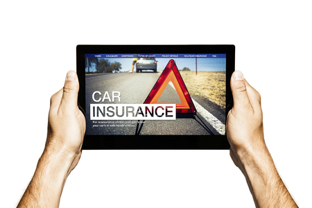 Hands holding a tablet with car insurance company website in the screen.の写真素材
