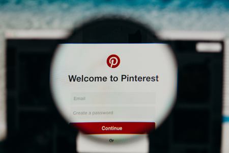 MALAGA, SPAIN - JUNE 3, 2017: Pinterest website detail in a computer screen, viewed through magnifying glass. Social media concept.のeditorial素材