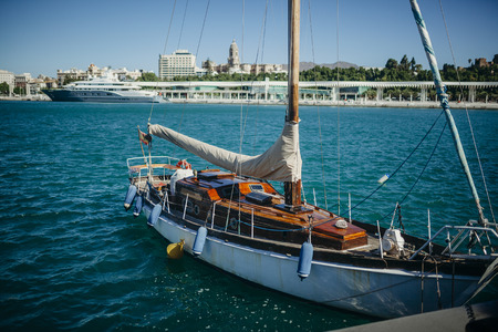 Old wooden sailboat docked at port. Dirty condition.の写真素材