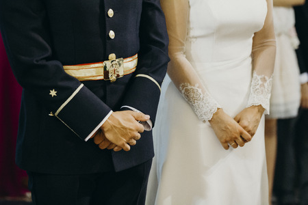 Groom and bride close up view of hands during ceremony.の写真素材