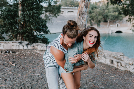 Natural couple embracing in a funny way in nature.の写真素材