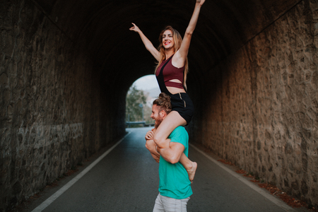 Man carrying his girlfriend on his shoulders. Alternative coupleの写真素材