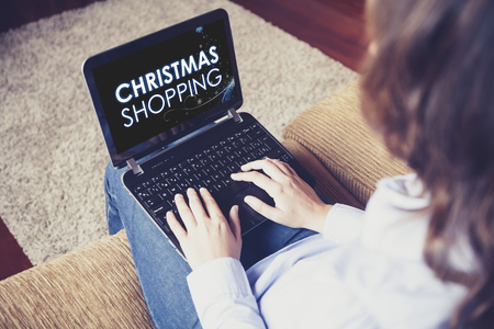 Woman doing Christmas shopping by internet with a laptop.の写真素材