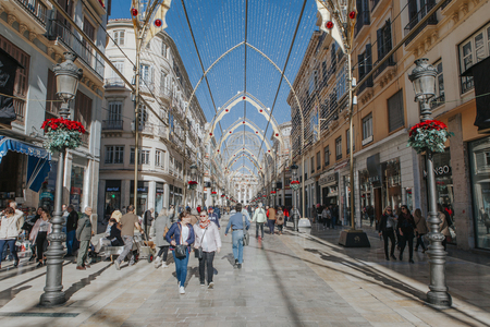 MALAGA, SPAIN - DECEMBER 5th, 2017: View of Malaga Larios Street life, with Christmas ornament, and people walking along it, on December 5th, 2017.のeditorial素材