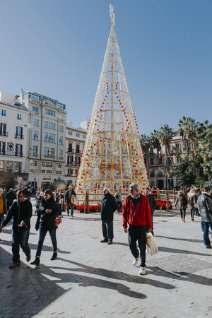 MALAGA, SPAIN - DECEMBER 5th, 2017: View of Malaga city center life at christmas , with people walking in the street and shops and restaurants around it, on December 5th, 2017.のeditorial素材