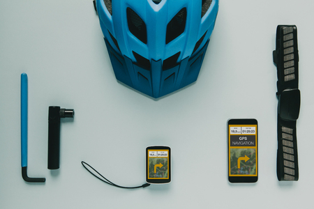 Cycling computer GPS, mobile phone and accessories on blue background.の写真素材
