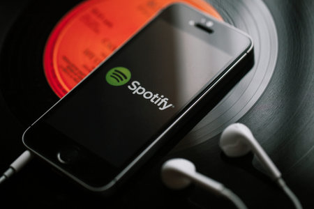 MALAGA, SPAIN - MARCH 5, 2018: Mobile phone with Spotify Music service in the screen and white...