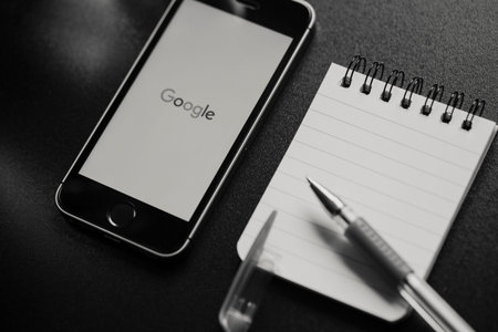 MALAGA, SPAIN - MARCH 6, 2018: Black and white image of Google app in a mobile phone screen, placed...