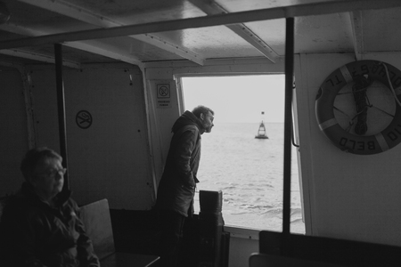 MARCH 24th, 2018 - OLHAO, PORTUGAL: Inside view of the public boat that connect the portuguese city of OlhÃ£o with Armona Island, during a regular trip with passengers traveling inside it, on March 24th, 2018.のeditorial素材