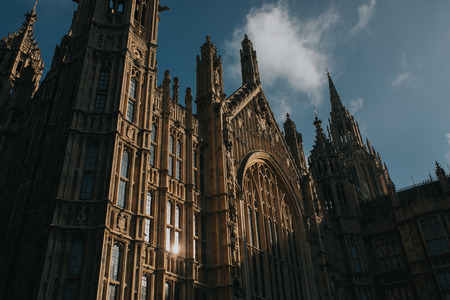 Westminster Palace, London. Old Palace Yard facade detail, with sun lighting and blue sky background.のeditorial素材