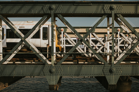 Train bridge iron structure and train going on it.の写真素材