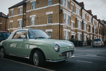 LONDON, ENGLAND - 25th October, 2018: A clean beautiful Nissan Figaro parked in a London street in a sunny day in a residential area of the city. England.のeditorial素材