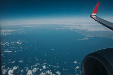 Plane engine and wing  with blue seascape in the background