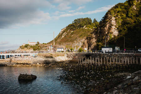 Cudillero, Spain - August 25th, 2020: Seascape of Cudillero village fishing port and lighthouse, in a cloudy day, in the north of Spain, in Asturias.のeditorial素材