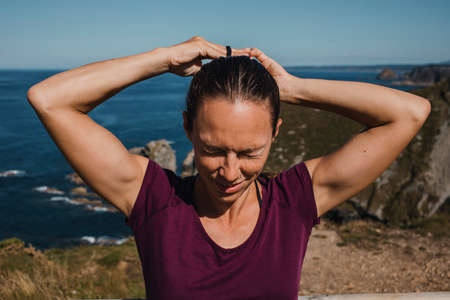 White woman laughing while look at the ocean at the sea shore.の写真素材