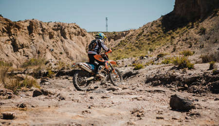 Almeria, Spain - May 5th 2021: Motocross rider crossing a river in Tabernas desert during Dunlop Xperience showroom and test in Almeria, Spain.のeditorial素材