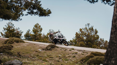 Sierra de los Filabres, Spain - May 5th 2021: Motorbike rider riding BMW R 1250 GS motorcycle in a mountain road across beautiful turns, during Dunlop Xperience event in Sierra de los Filabres, Spain.のeditorial素材