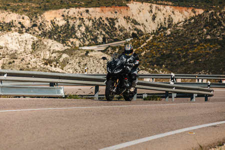 Almeria, Spain - May 5th 2021: Man riding a BMW R 1250 RS motorcycle in a mountain road, during Dunlop Xperience event in Andalusia, Spain.のeditorial素材