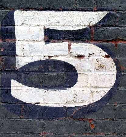 number five painted on brick wallの写真素材