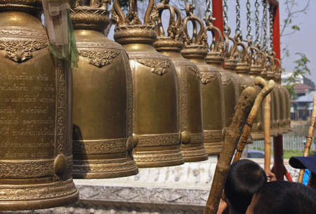 children ring the bells thailandの写真素材