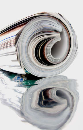  rolled up magazine with reflectionの写真素材