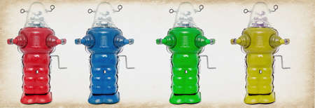 red blue green and yellow robot toys in a line の写真素材