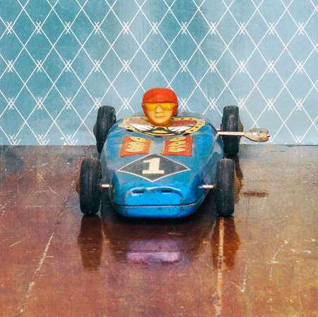 rerto racing car on old wooden floor with reflectionの写真素材