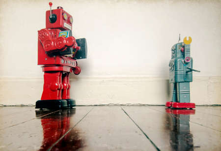 stick them up , robo cop puts robot undr arrest , on old wooden floor with reflectionの写真素材