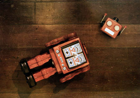 retro red robot has lost his head on a old wooden floor from aboveの写真素材