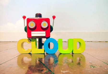 red retro robot head on the word CLOUD  on old wooden floorの写真素材