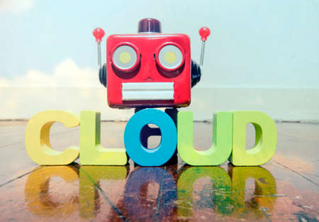 red retro robot head on the word CLOUD  on old wooden flor の写真素材