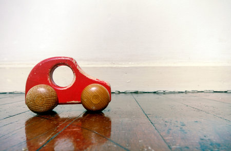 retro  red wooden car toy on a old wooden floor 