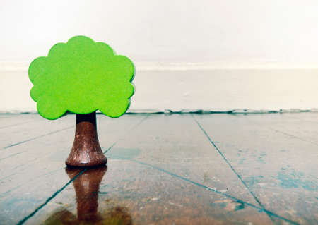 old wooden tree toy on a wooden floor の写真素材